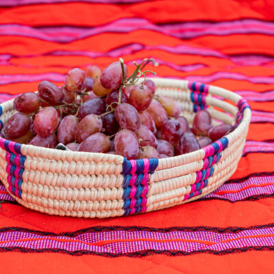 Handwoven Oval Serving Basket with Pink and Blue Accents