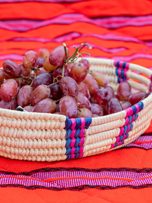 Handwoven Oval Serving Basket with Pink and Blue Accents